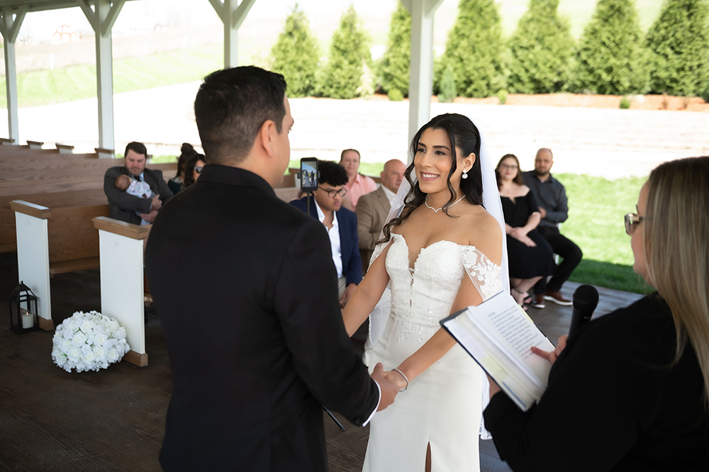 Bride and groom holding hands during ceremony