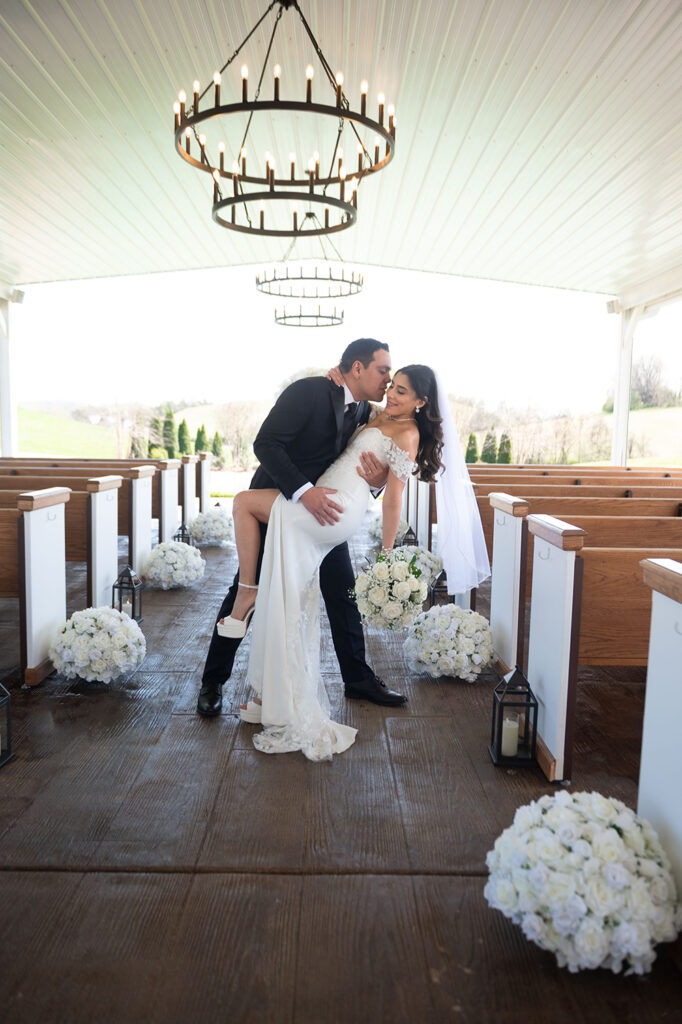 Groom lifting the bride’s hand to kiss it