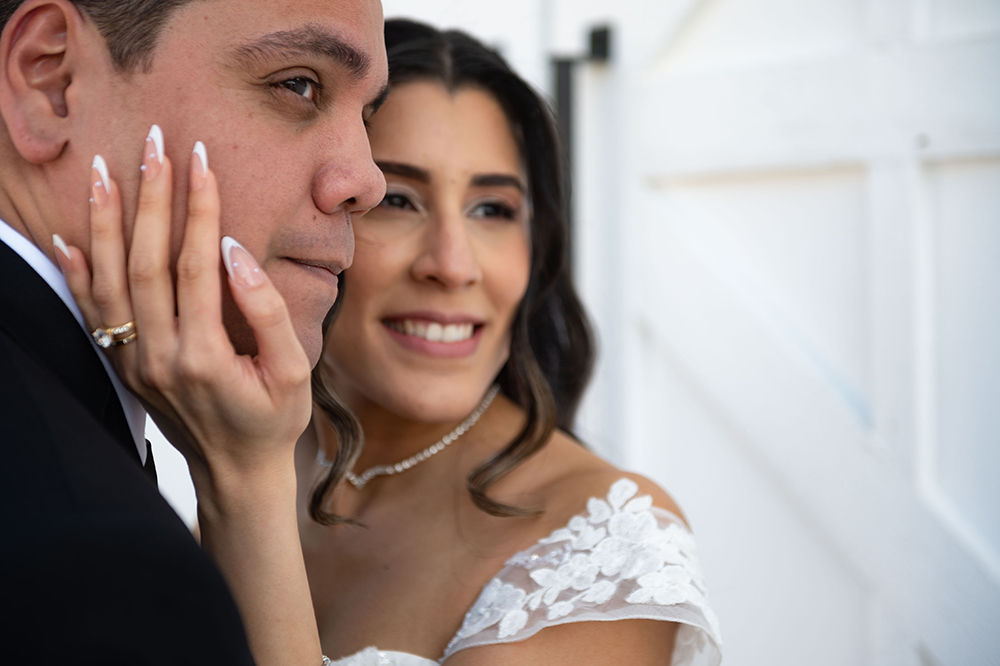 Bride kissing groom on the cheek