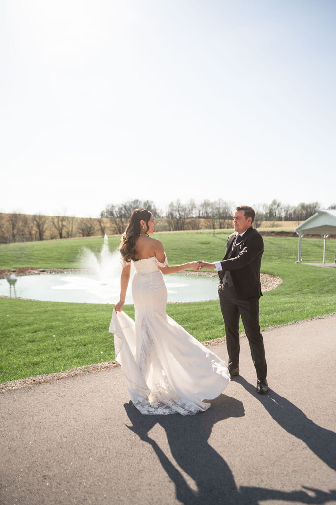 The couple walking through a grassy field