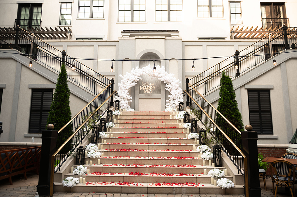 Symmetrical staircase decor for surprise engagement in downtown Franklin