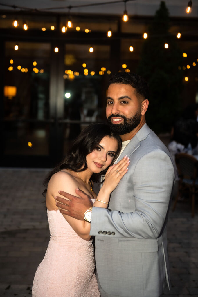Couple hugging right after the proposal in beautiful open-air courtyard