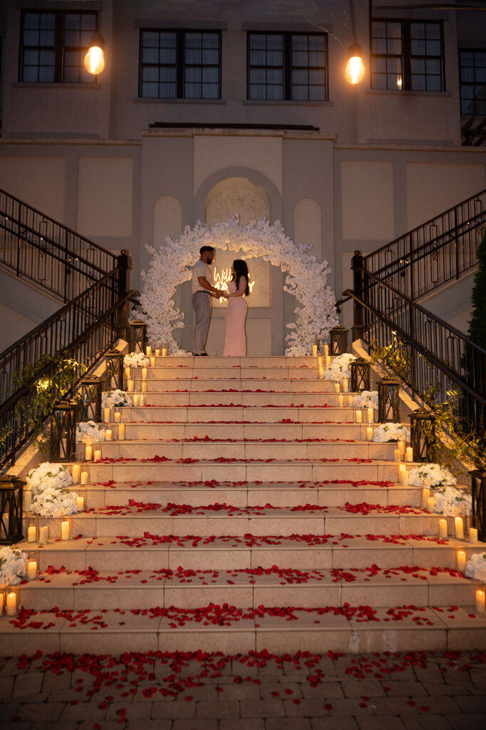 Romantic proposal setup with candles and flowers on the staircase at Harpeth Hotel